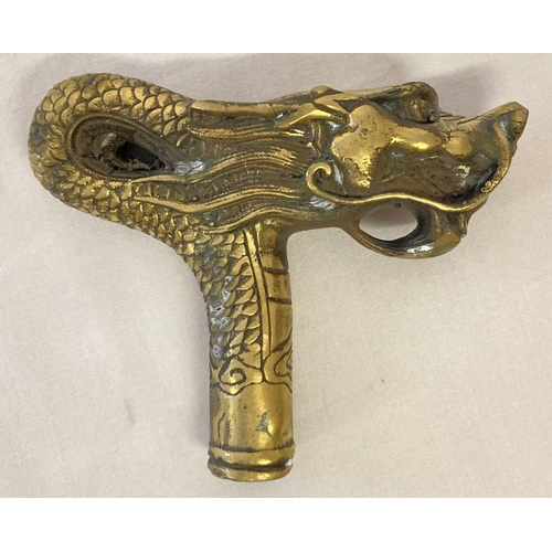 1136 - A brass walking cane handle in the shape of a dragon.  Approx. 10cm x 12cm.