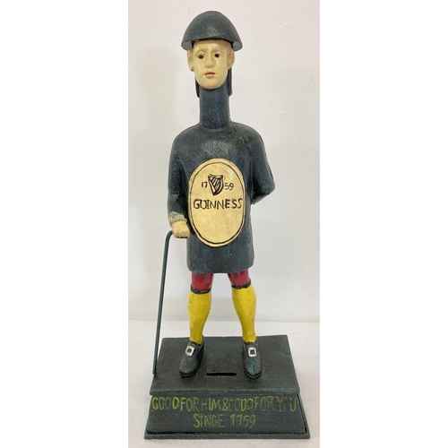 1142 - A painted cast iron Guinness advertising figural money box.  Approx. 36cm tall.