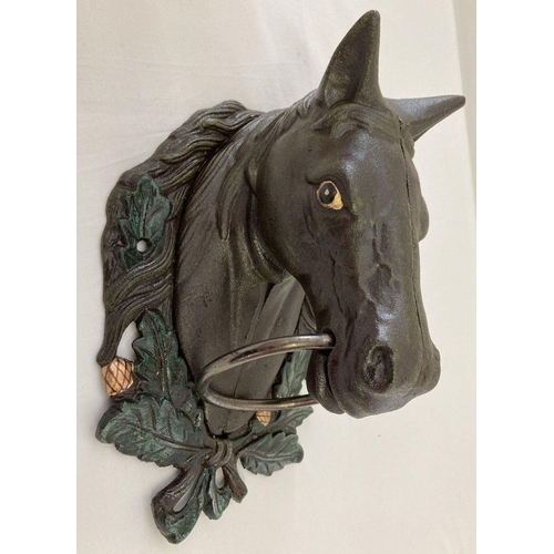 1146 - A large painted cast metal, wall mountable horse head with ring.  Approx. 29cm long.