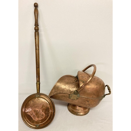 1150 - An antique copper swing handled coal scuttle with aged rivetted repair to base. Together with a vint... 