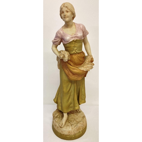 1163 - A large Royal Dux porcelain figure of a young girl in traditional dress carrying wheat. Makers stamp... 