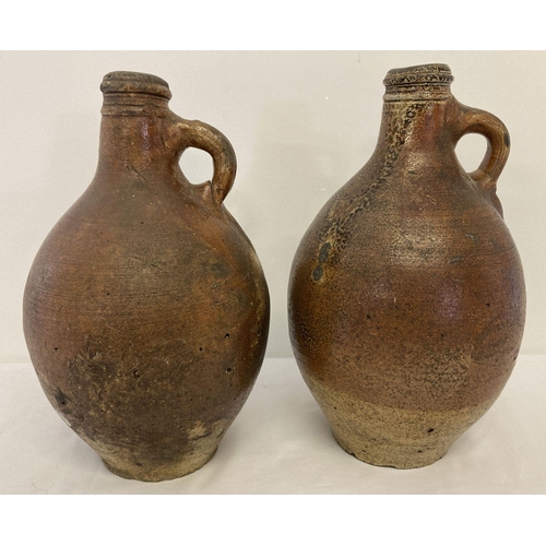 1168 - 2 antique Bellarmine stone ware jugs of bulbous form with circular detail to top rims.  Tallest appr... 
