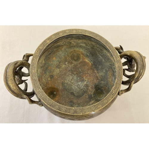 1197 - A large vintage Chinese 2 handled censer with decorative dragon shaped handles. Raised on tripod fee... 