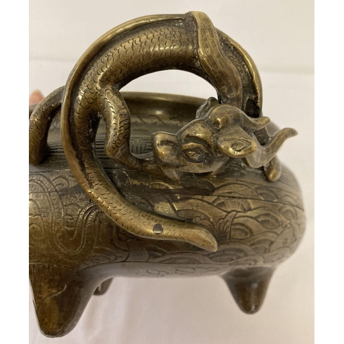 1197 - A large vintage Chinese 2 handled censer with decorative dragon shaped handles. Raised on tripod fee... 