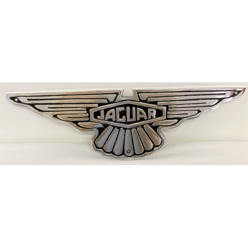 1241 - A Jaguar motors aluminium wall hanging plaque with black painted detail.  Approx. 15cm x 49cm.