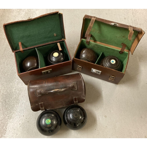 1253 - 3 pairs of vintage lawn bowls complete with leather cases.