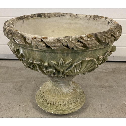 1353 - A large carved stone pedestal round planter with scallop shell and floral decoration.  Approx. 48cm ... 