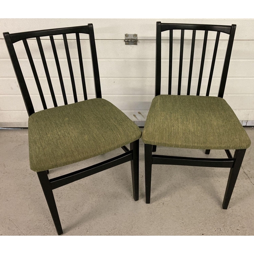 48 - A pair of retro black wooden stick back style kitchen/dining chairs with green upholstery seats.