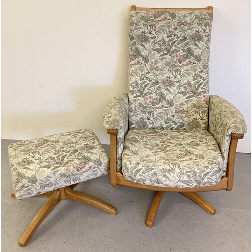 54 - An Ercol light wood framed swivel/reclining easy chair and matching footstool. Both with floral & hu... 