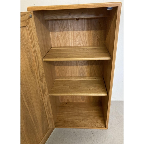 60 - A vintage light elm Ercol Windsor single door cupboard with 2 adjustable interior shelves.  Approx. ... 