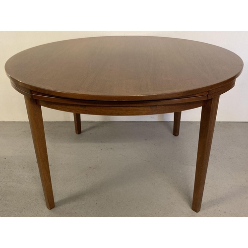 65 - A vintage Danish teak circular flip flap lotus dining table by Dyrlund. Raised on 4 tapered legs, ce... 