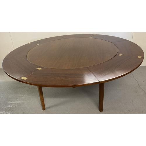 65 - A vintage Danish teak circular flip flap lotus dining table by Dyrlund. Raised on 4 tapered legs, ce... 