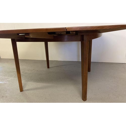 65 - A vintage Danish teak circular flip flap lotus dining table by Dyrlund. Raised on 4 tapered legs, ce... 