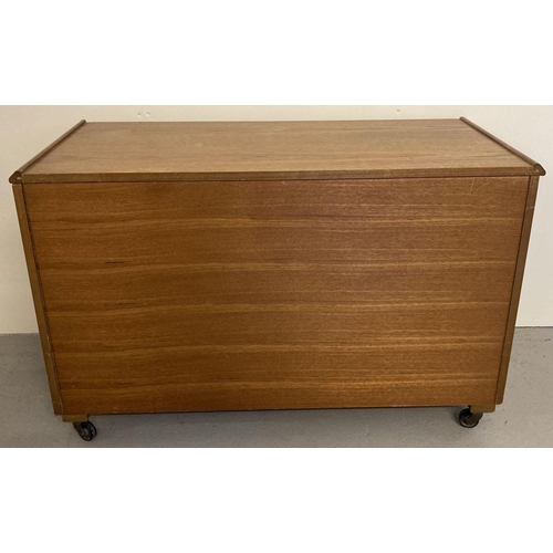 66 - A vintage teak blanket box on castor feet with lift up hinged lid.  Approx. 59cm x 92cm x 43cm.