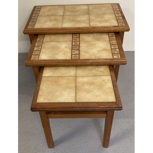 68 - A nest of 3 vintage tile topped occasional tables. Teak tables set with brown and beige coloured til... 