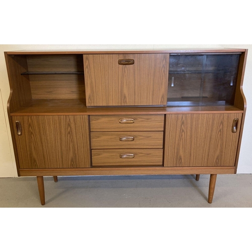 71 - A vintage mid century Schreiber teak sideboard with sliding doors, drawers and glass shelves. Raised... 