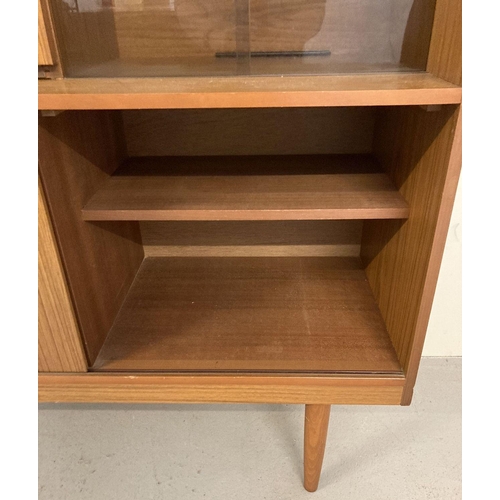 71 - A vintage mid century Schreiber teak sideboard with sliding doors, drawers and glass shelves. Raised... 