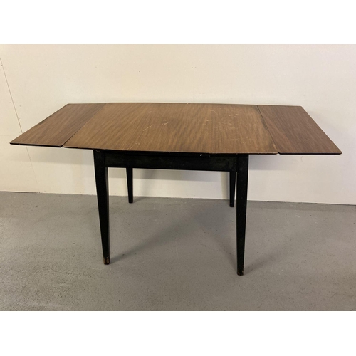 75 - A vintage 1960's teak draw leaf kitchen table with veneered top and with ebonised legs and frame.  A... 