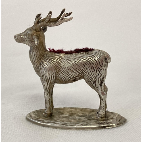 1113 - A novelty silver stag shaped pin cushion with worn red velvet cushion. Lion passant and date mark vi... 