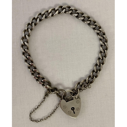 1053 - A vintage silver charm bracelet with padlock clasp and safety chain. Marked 'silver' to back of padl... 