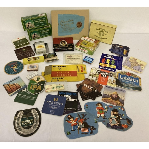 210 - A collection of assorted advertising boxes, packaging and beer mats. To include matchboxes, cigarett... 