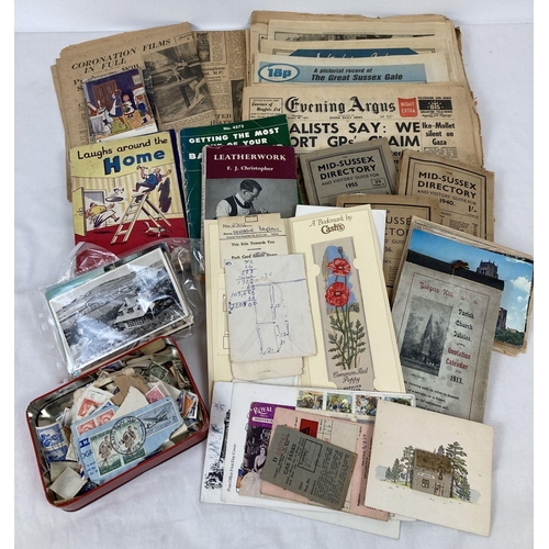 284 - A quantity of assorted vintage ephemera to include stamps, postcards, newspapers & books. Lot includ... 