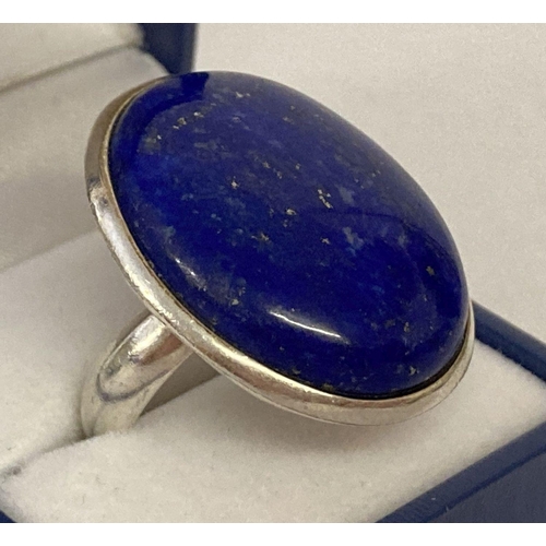 1012 - A modern silver statement dress ring set with a large oval lapis lazuli stone. Marked 925 to inside ... 