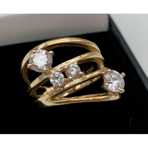 1048 - A silver gilt dress ring in a multi-ring design, set with varying sized round cut DQCZ stones by Ver... 