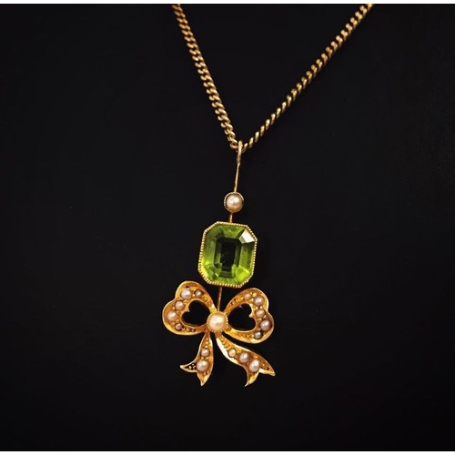 5 - An antique 18ct gold peridot and seed pearl pendant with bow detail on a 14ct gold fine curb chain. ... 