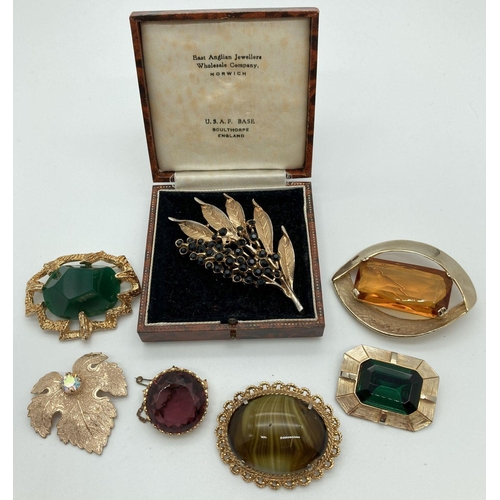 240 - A collection of 7 large 1960's & 70's stone set brooches in gold coloured mounts. To include example... 