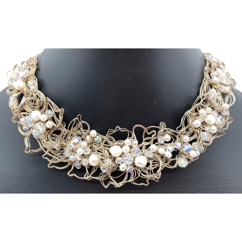 256 - A bespoke made collar style necklace made from white metal wires in a floral design with aurora bore... 