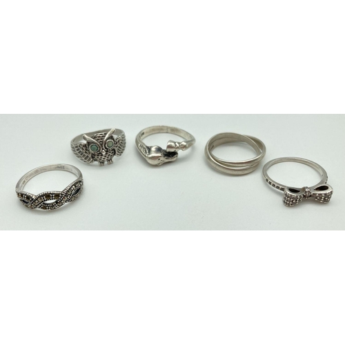 58 - 5 silver dress rings, some stone set. A band ring with horse head and hoof detail, an owl ring with ... 