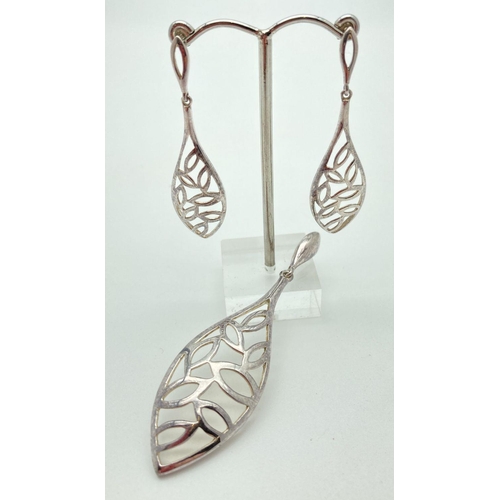 69 - A large silver leaf design, pierced work teardrop shaped pendant with matching drop earrings. All ma... 