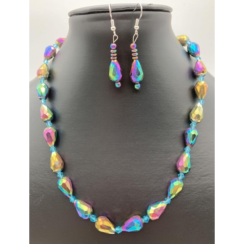 268 - A faceted iridescent lustre glass beaded necklace with matching drop earrings. Necklace has silver t... 