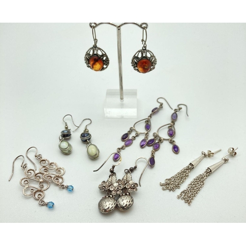 74 - 6 pairs of silver and white metal drop style earrings. To include amber and amethyst set.