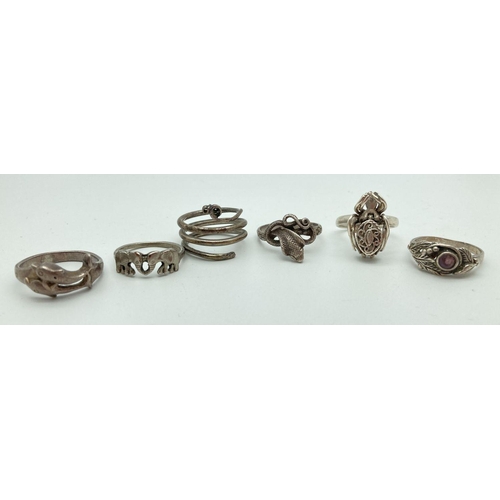 100 - 6 silver and white metal dress rings in varying styles, conditions and sizes to include animal desig... 