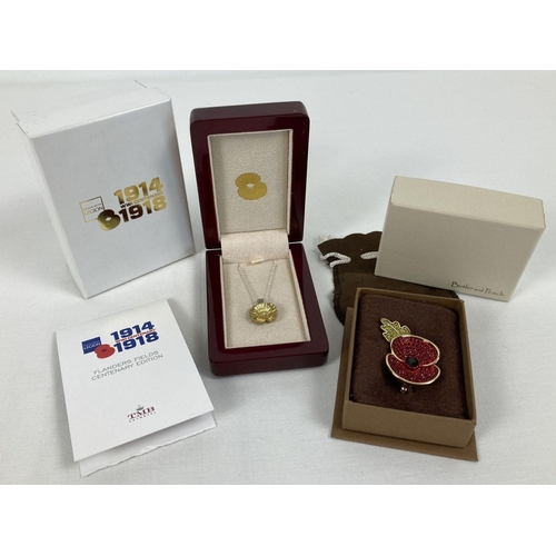 272 - 2 boxed items of poppy day commemorative jewellery. A Flanders Fields WWI Centenary poppy pendant on... 