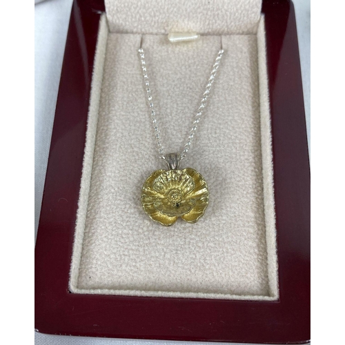 272 - 2 boxed items of poppy day commemorative jewellery. A Flanders Fields WWI Centenary poppy pendant on... 