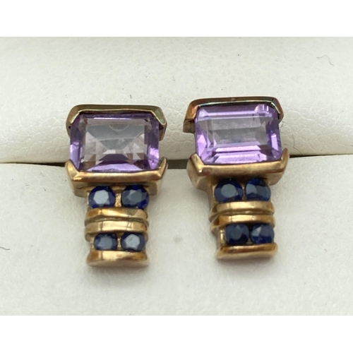15 - A pair of 9ct gold, amethyst and sapphire stud style earrings. Each earring set with a square cut am... 