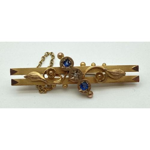 19 - An Edwardian 9ct gold floral design bar brooch set with a small round cut diamond and 2 small round ... 