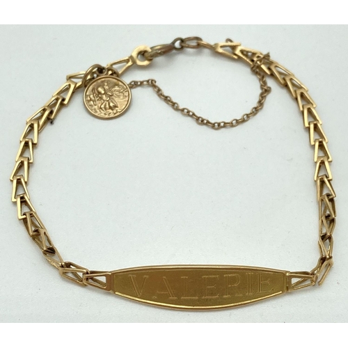 108 - A gold open foxtail style link identity bracelet with safety chain and small St. Christopher charm. ... 