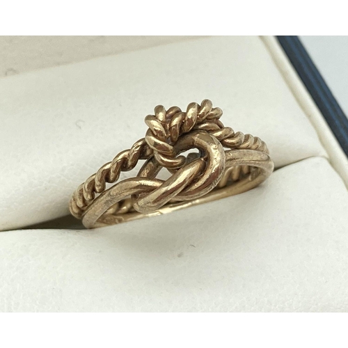 124 - A 9ct gold double band and knot ring. One band in rope design the other plain. Full hallmarks to the... 