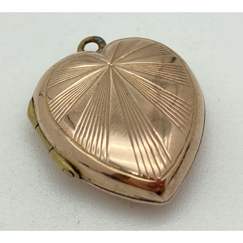 149 - A vintage 9ct gold heart shaped locket with sunray design to front. Gold marks to back. Total weight... 