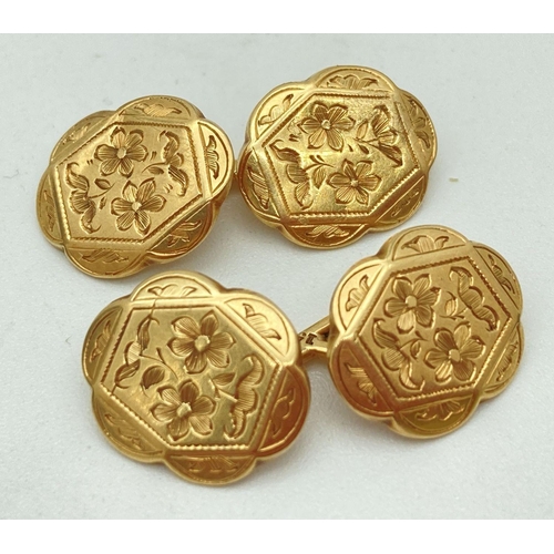 160 - A pair of vintage floral engraved 15ct gold cufflinks with scallop shaped edge. Total weight 5.7g.