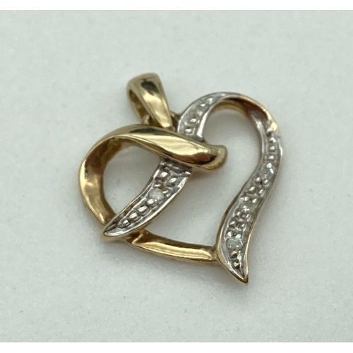 167 - A 9ct gold and diamond open heart pendant with 5 small illusion set round cut diamonds. Gold mark to... 