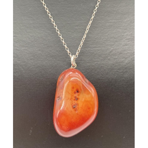 169 - A large carnelian stone pendant on an 18 inch silver belcher chain with spring clasp. Carnelian pend... 