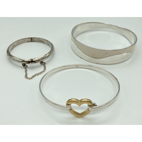 174 - 3 silver and silver plated bangles. A child's hinged bangle with diamond cut pattern and safety chai... 