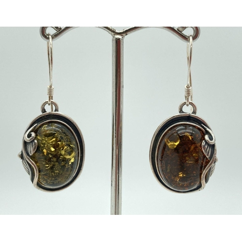 218 - A pair of green amber and silver Art Nouveau style drop earrings. Each approx. 2.8cm long excluding ... 