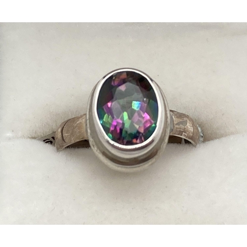 219 - A modern design silver dress ring set with an oval mystic topaz stone. Ring size O. Stone approx. 1c... 