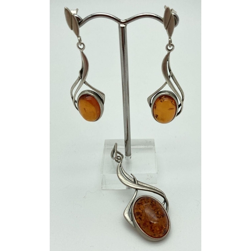 188 - An Art Nouveau style modern silver and amber pendant and matching drop earrings. Pendant approx. 5cm... 